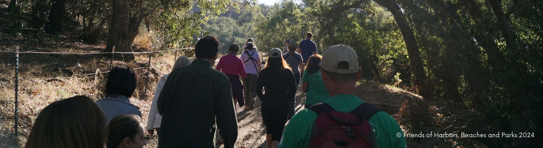 Hike group in Trabuco Rose Park in the shade. Riparian habitat with shady spots and sun flowing throughout